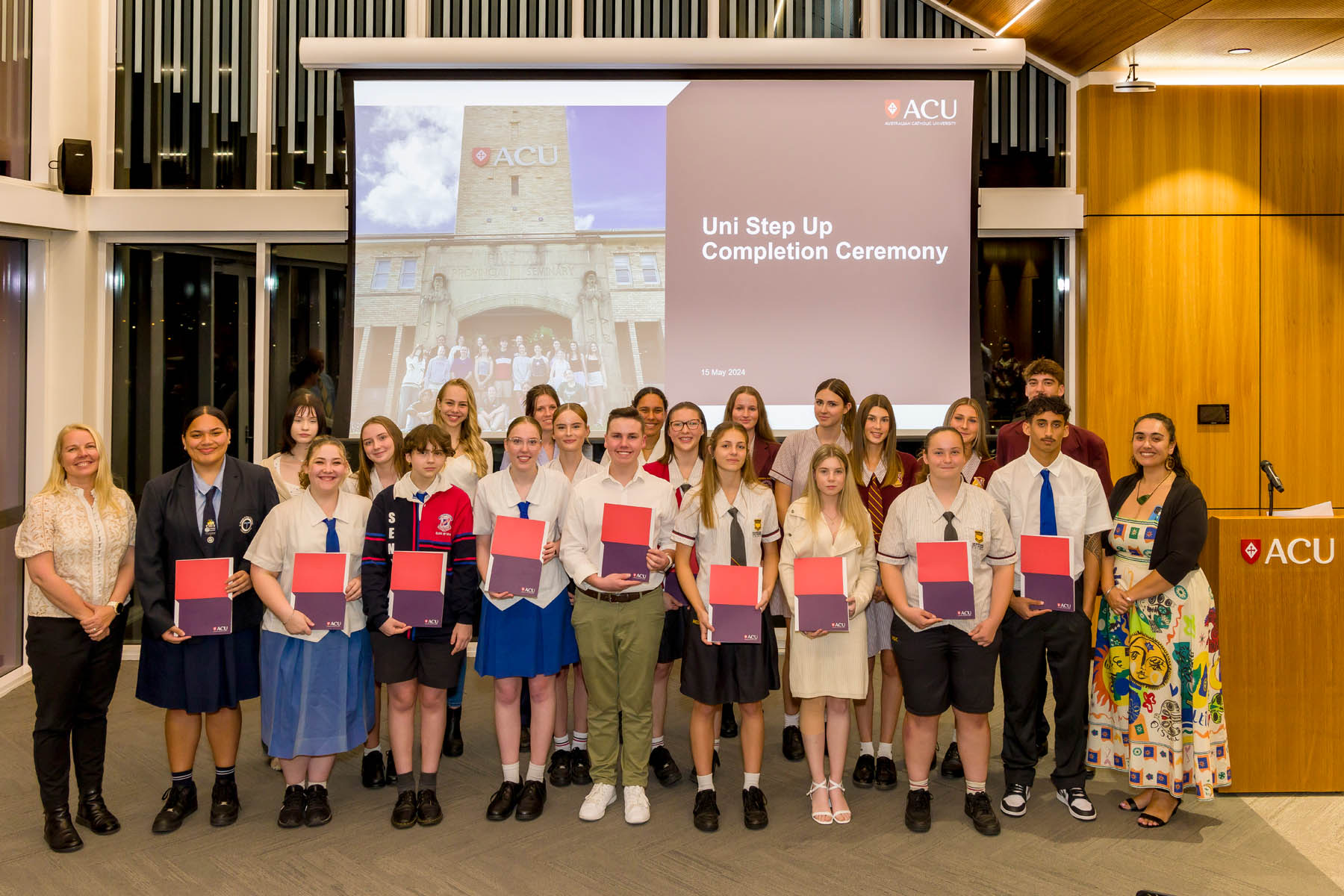 Students receiving certificates during a school partnership awards ceremony celebrating achievement, pathways and future study opportunities