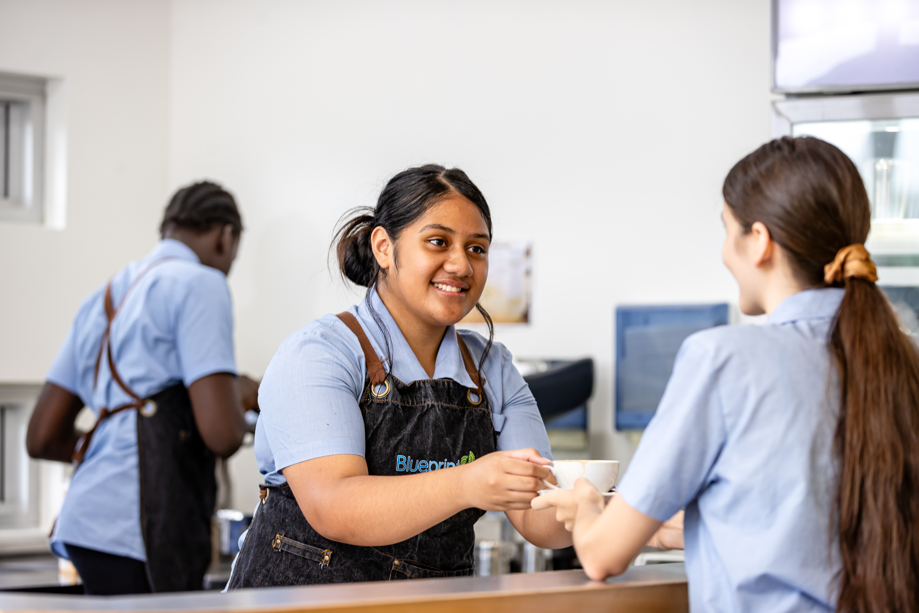 Students developing hospitality skills by preparing and serving drinks, supporting teamwork, communication and real world learning