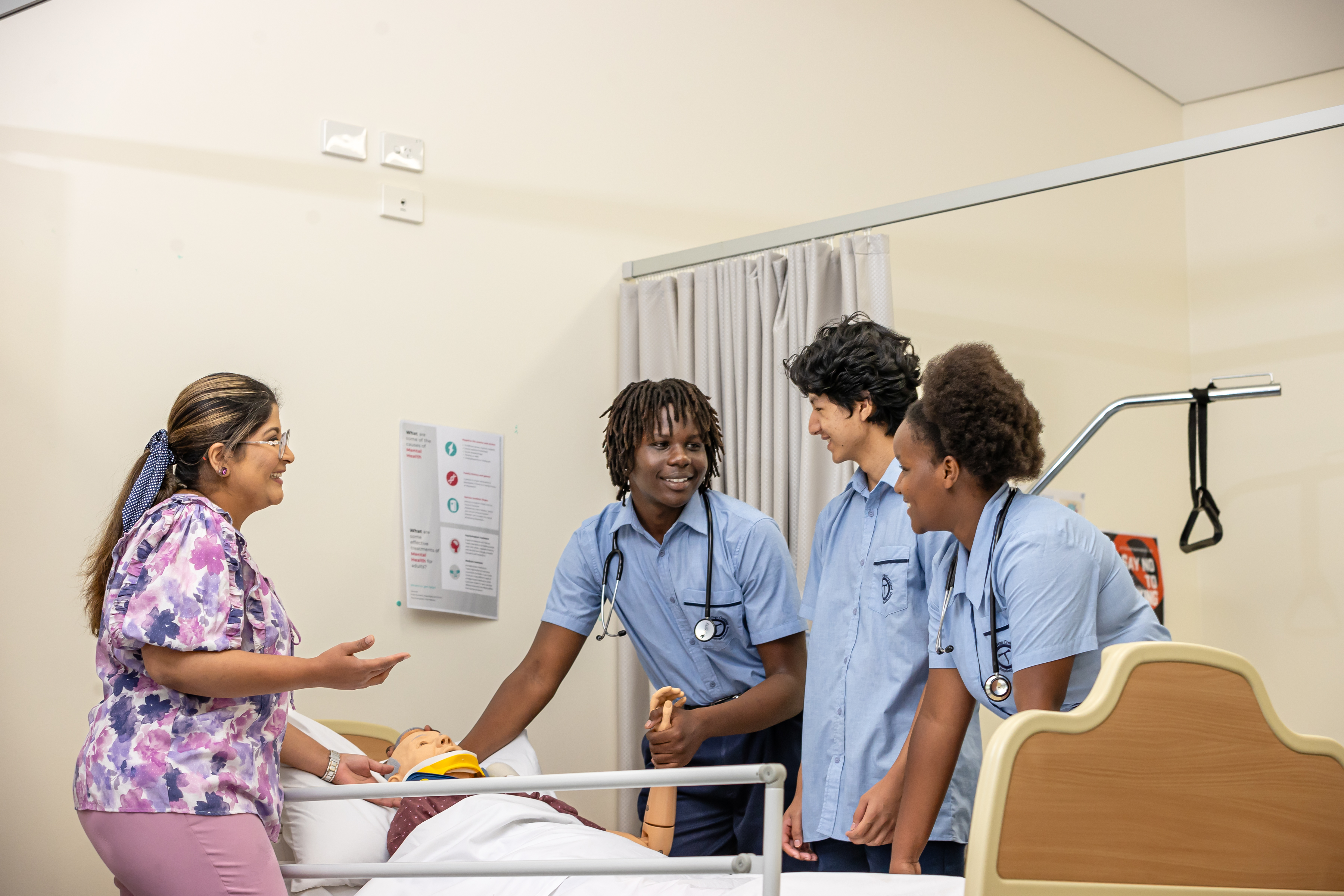 Students participating in health training with teacher guidance, practicing practical care skills and collaborative learning in a simulated clinical environment